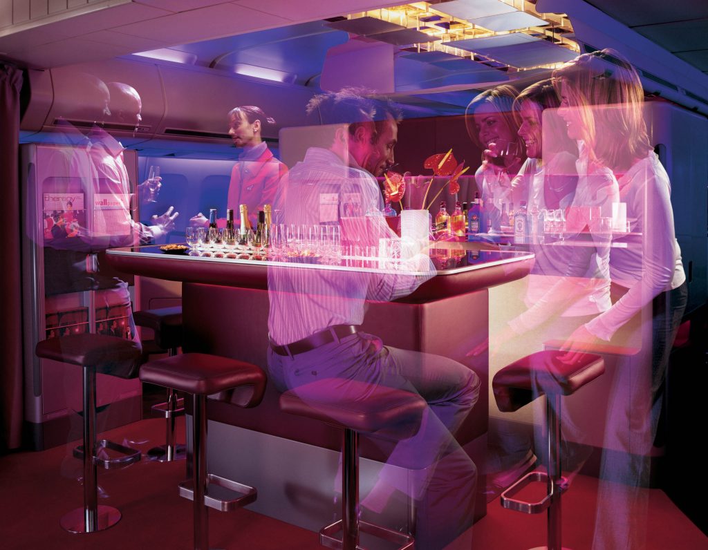 Virtual Reality Scene showing people gathered around a bar area inside a plane